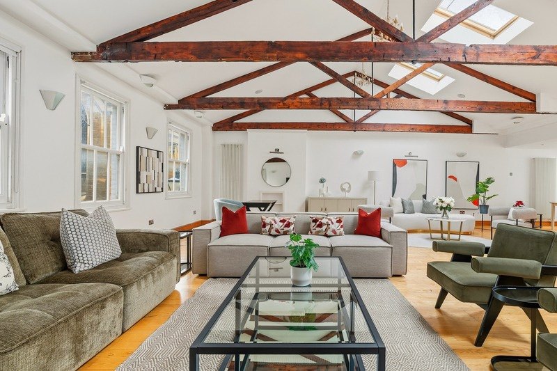 A loft reception room with vaulted ceiling and timber beams